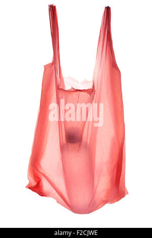translucent pink plastic bag with water bottle inslde hangs invisibly from a white background Stock Photo