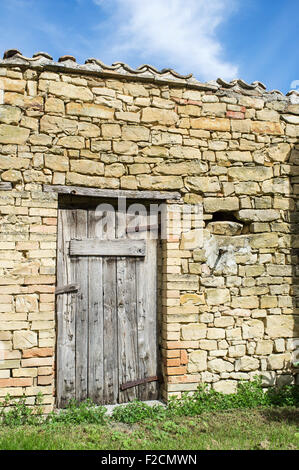 Old Stone Barn in Le Marche with Weathered Wooden Door Stock Photo