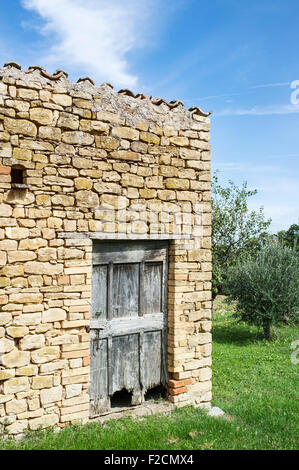 Old Stone Barn in Le Marche with Weathered Wooden Door Stock Photo