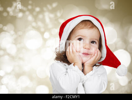 Funny child dressed santa hat, on bokeh background Stock Photo