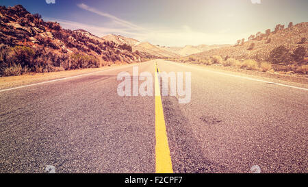 Retro vintage old film style endless country road, travel adventure concept, space for text, USA. Stock Photo