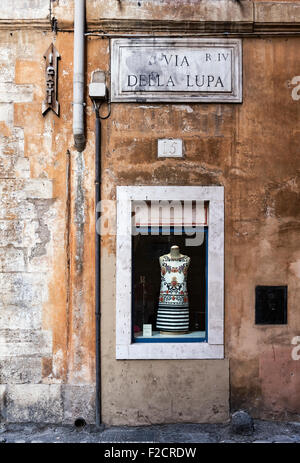 Dress shop window display on old street, Rome, Italy Stock Photo