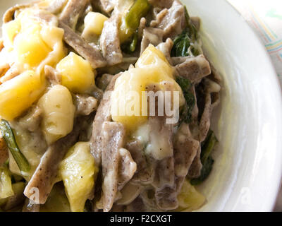 A plate of pizzoccheri, a traditional pasta dish of the Valtellina area in northern Italy Stock Photo