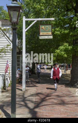 Actors in period clothes walking past post office Colonial Williamsburg living-history museum Virginia Stock Photo