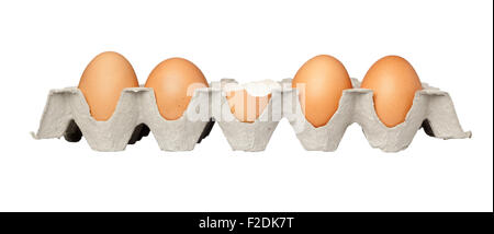 One cracked egg in a tray of eggs isolated on white background Stock Photo