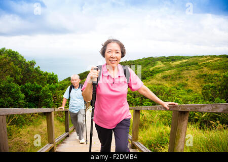 happy senior couple hiking on the mountain Stock Photo