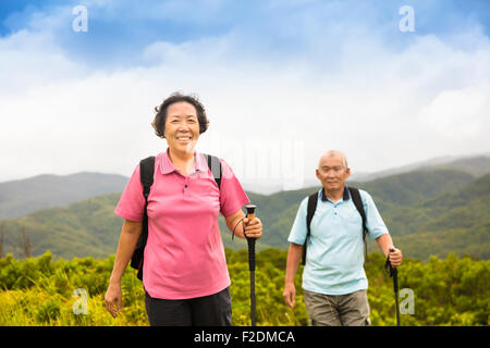 happy senior couple hiking on the mountain Stock Photo