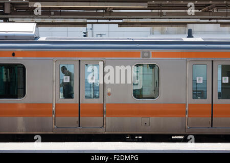 Orange stripe train Chuo Line Japanese train side view Stock Photo