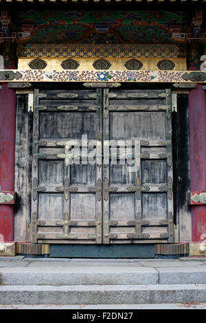 Ancient wooden shrine temple door with metal details Stock Photo