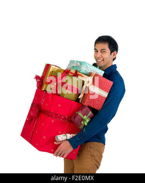 Happy young man holding too many Christmas presents Stock Photo