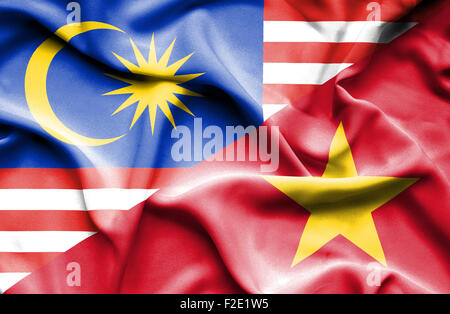 Waving flag of Vietnam and Malaysia Stock Photo