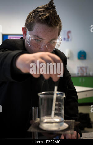 A pupil pictured during a Year 9 science class at Kirkby High School, Merseyside. The school had one of the lowest success rates for GCHE passes in 2014 in England. In 2013 the school changed from local authority to Academy status. Stock Photo