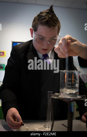 A pupil pictured during a Year 9 science class at Kirkby High School, Merseyside. The school had one of the lowest success rates for GCHE passes in 2014 in England. In 2013 the school changed from local authority to Academy status. Stock Photo