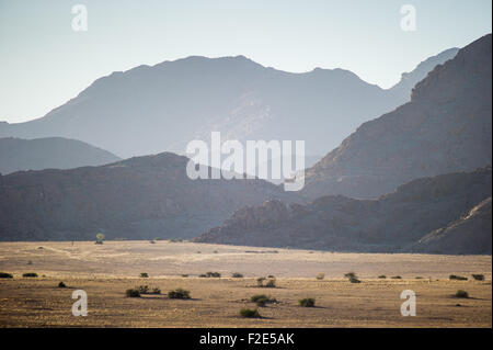 Open Landscape with cascading mountains in the distance in Namibia, Africa Stock Photo