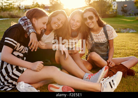Best friends hanging out on a summer evening in a park Stock Photo