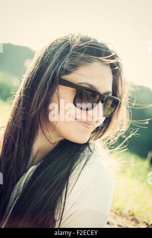 Portrait of a teenager with sunglasses photographed in backlight Stock Photo