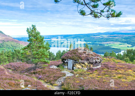 ABRIACHAN TRAIL OR WALK ABOVE LOCH NESS  THE SHIELING HUT  SURROUNDED BY PURPLE HEATHER  IN LATE SUMMER AND VIEW TO INVERNESS Stock Photo