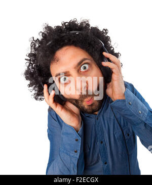 Young surprised man with headphones on white background. Stock Photo