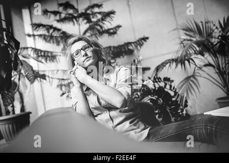 Portrait of a beautifil businesswoman working with laptop i modern office scenery. Stock Photo