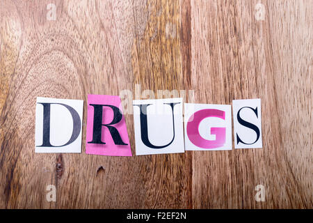 drugs written made with letters of newspaper on wood Stock Photo