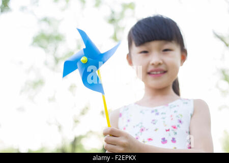 Happy girl holding a pinwheel Stock Photo