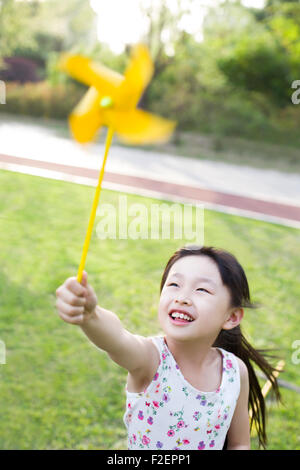Happy girl playing with pinwheel Stock Photo