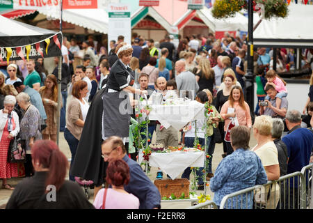 ALDI sponsored 10th Bolton Food and Drink Festival 2015   on stilts large lady maid trolly res coffee china uniform  performing Stock Photo