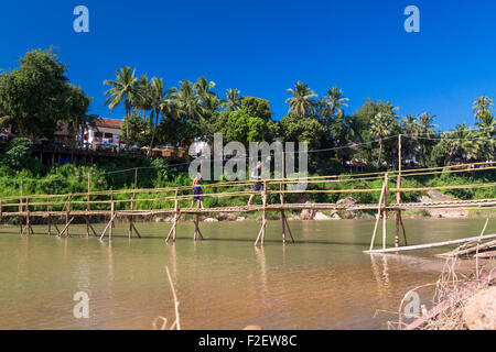 Tourists on bridge across Nam Khan river, Luang Prabang, Laos Stock Photo