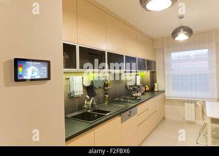Remote home control system on a digital tablet or phone. Stock Photo
