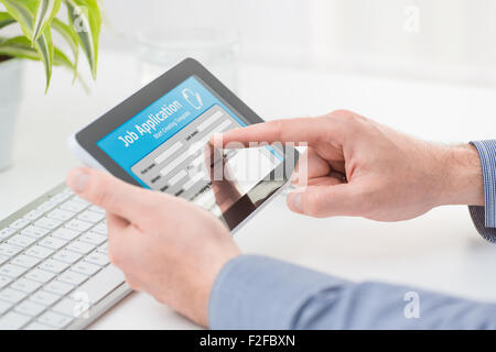 Applicant filling up the online job application by digital tablet. Stock Photo