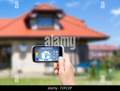 Remote home control system on a digital tablet or phone. Stock Photo