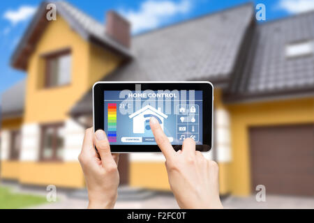 Remote home control system on a digital tablet or phone. Stock Photo