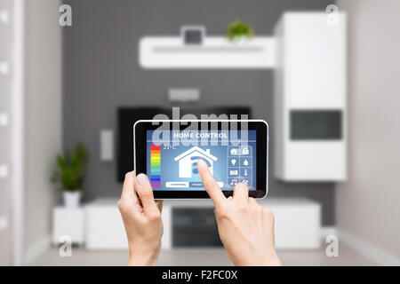 Remote home control system on a digital tablet or phone. Stock Photo