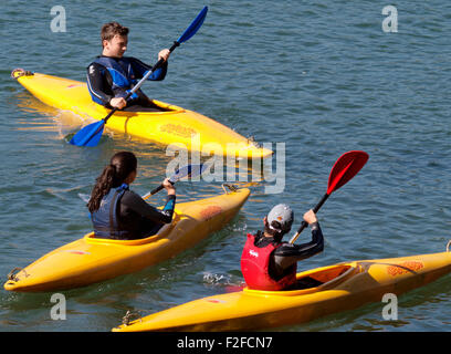Teenagers kayaking on the River Yealm, Newton Ferrers, Devon, UK Stock Photo
