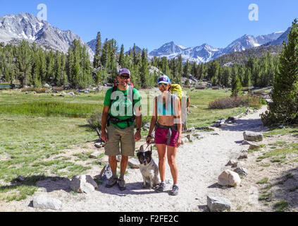 Couple with dog in Little Lakes Valley in Rock Creek Canyon in the Eastern Sierra Stock Photo