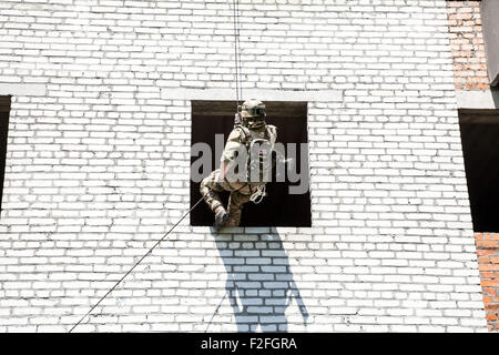 rappeling with weapons Stock Photo