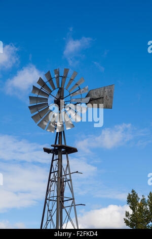 Windmill used for power generation or pumping water on a farm Stock Photo