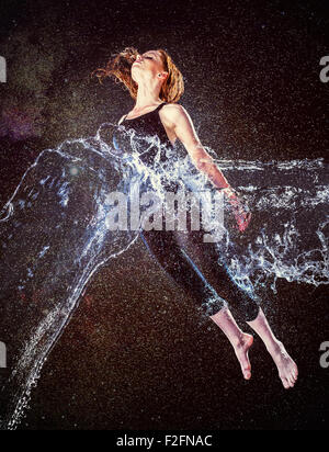 Thoughtful Woman in Water Splash Floating in Air Stock Photo