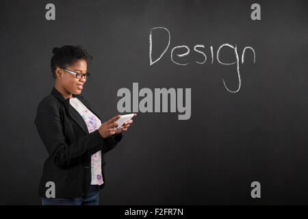 South African or African American black woman teacher or student holding a tablet designing something Stock Photo