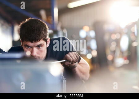 Mechanic working in auto repair shop Stock Photo