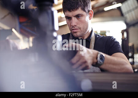 Focused mechanic working in auto repair shop Stock Photo