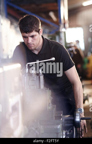 Mechanic working at machinery in auto repair shop Stock Photo