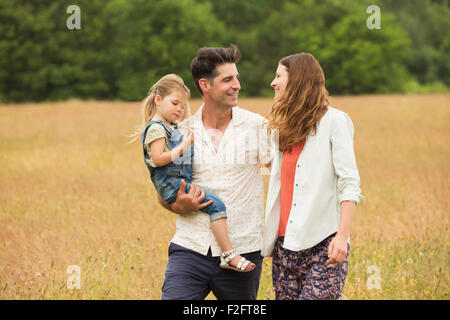 Family walking in rural field Stock Photo