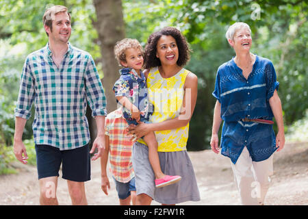Multi-generation family walking in woods Stock Photo