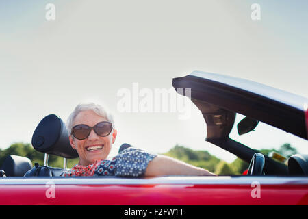 Portrait senior woman driving convertible Stock Photo