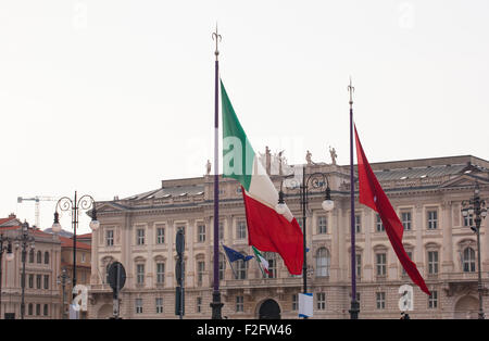 View of Italian and Trieste flags blowing in the wind Stock Photo