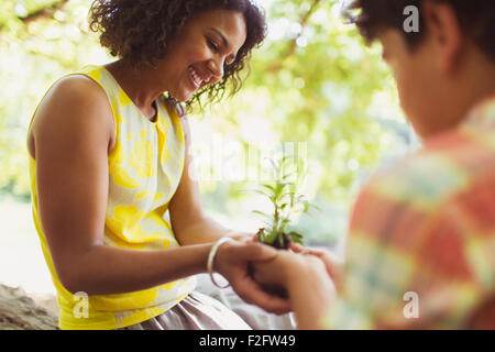 Mother and son cupping seedling outdoors Stock Photo