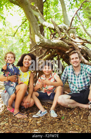 Portrait smiling family in woods Stock Photo