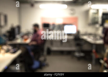 Out of focus shot of technician working in a computer repair shop Stock Photo