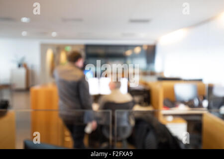 Out of focus shot of two white collar workers working together on a computer Stock Photo